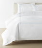 Filigree Duvet Set arranged on a bed against a white wall, Sky