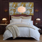 Decorative bedroom with Filigree Classic Duvet Set on the bed, a maroon headboard, and floral wall art.