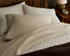 Heritage Linen Coverlet in a natural color styled with the All Seasons Brushed Cotton Sheet Set on a wooden bed.