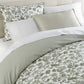 Highgrove Toile Reversible Duvet Set in Highgrove Moss on a bed with a cream colored headboard