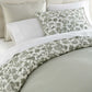 Highgrove Toile Reversible Duvet Set in Highgrove Moss on a bed with cream colored headboard