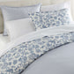 Highgrove Toile Reversible Duvet Set in Highgrove Moss on a bed with cream colored headboard striped