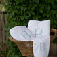 Jubilee Towel monogramed and displayed in a wicker basket, White