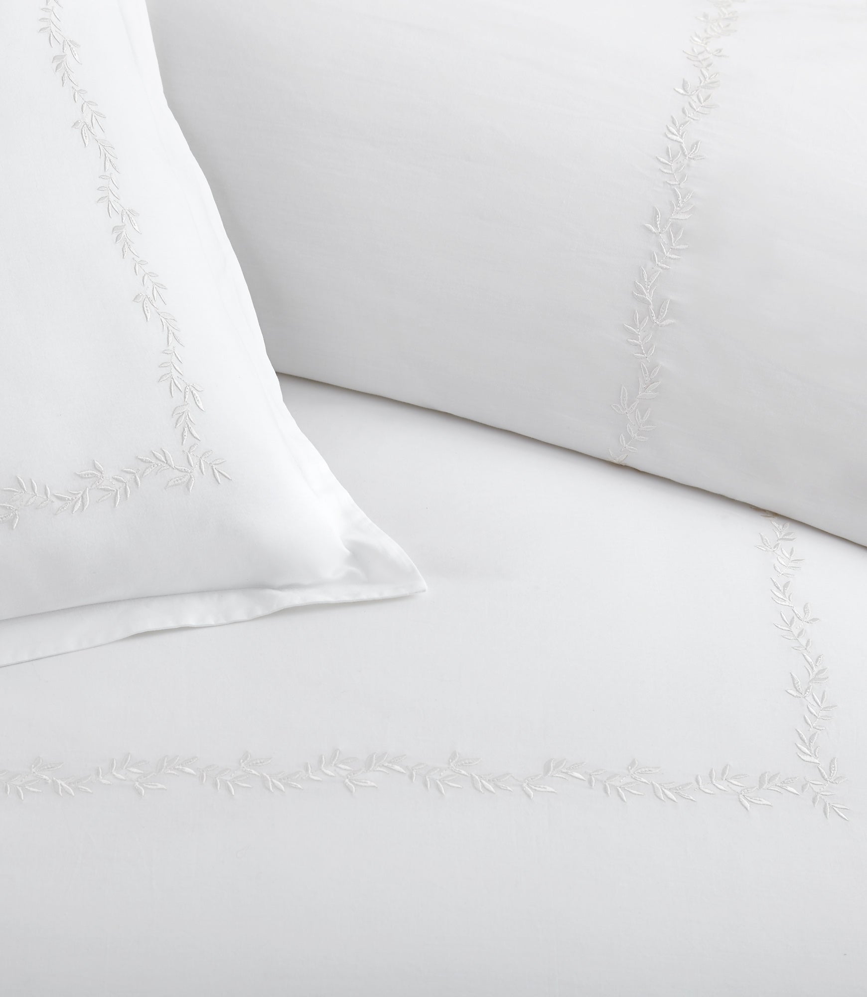 Close up of vine detailing on the Ivy Classic Embroidered Duvet Set, White