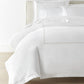 Ivy Classic Embroidered Duvet Set displayed on a bed with a cream colored headboard, Linen