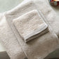 Jubilee Bath Towels folded on bathtub, Linen