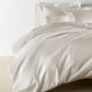 Lyric Duvet Cover and Shams on Bed in Platinum
