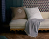 Embroidered Rio Shams displayed on a cream colored bench 