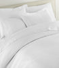 Montauk matelassé duvet cover and shams on bed, White