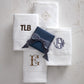 Monogrammed hand towels folded on counter, White