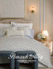 Bedroom with floral bedding and 'Peacock Alley' branding on a retail price guide cover.