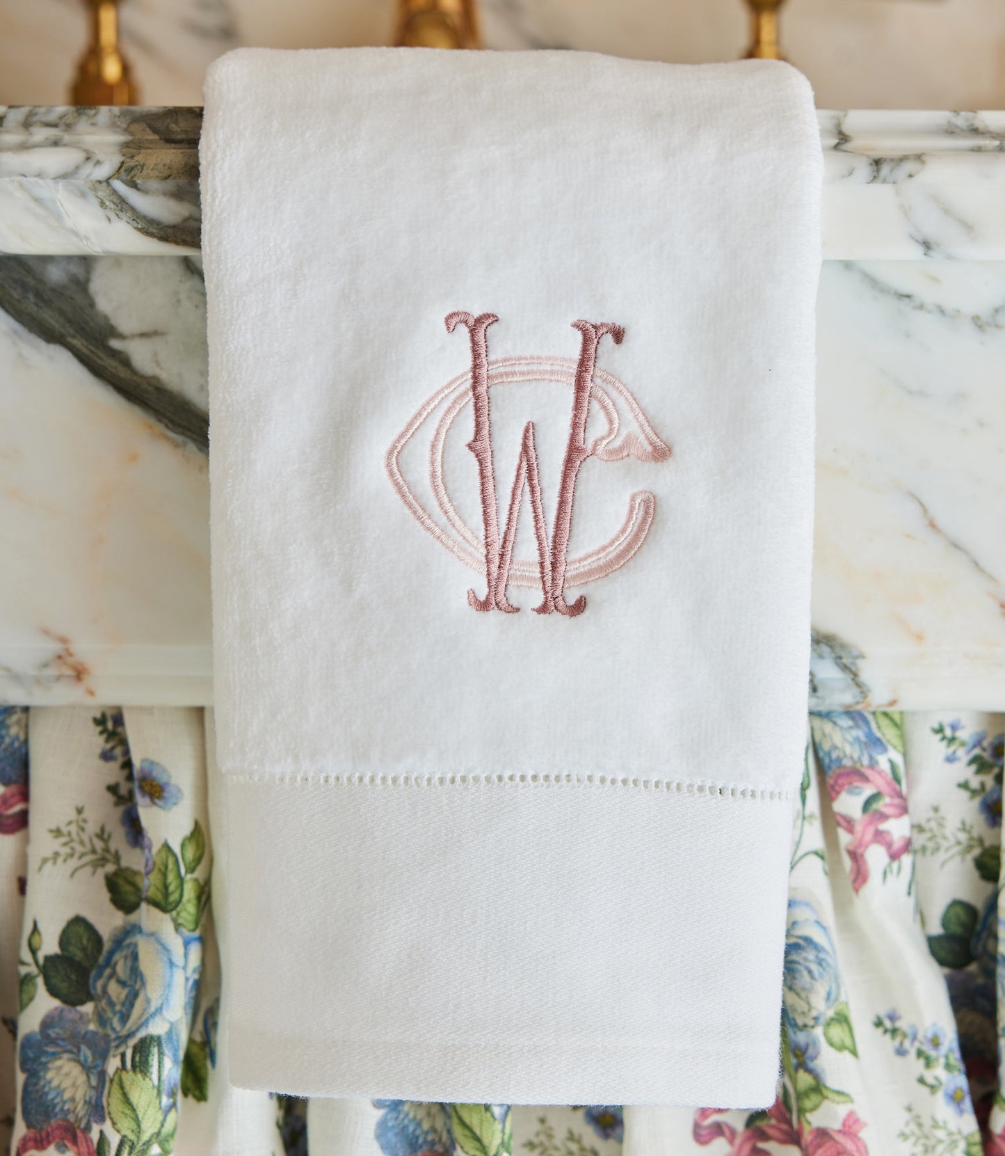 Special Occasion Hand Towel with pink embroidered monogram on a marble surface