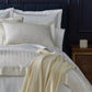 Soprano Stripe Sham on bed with blue headboard, Ivory
