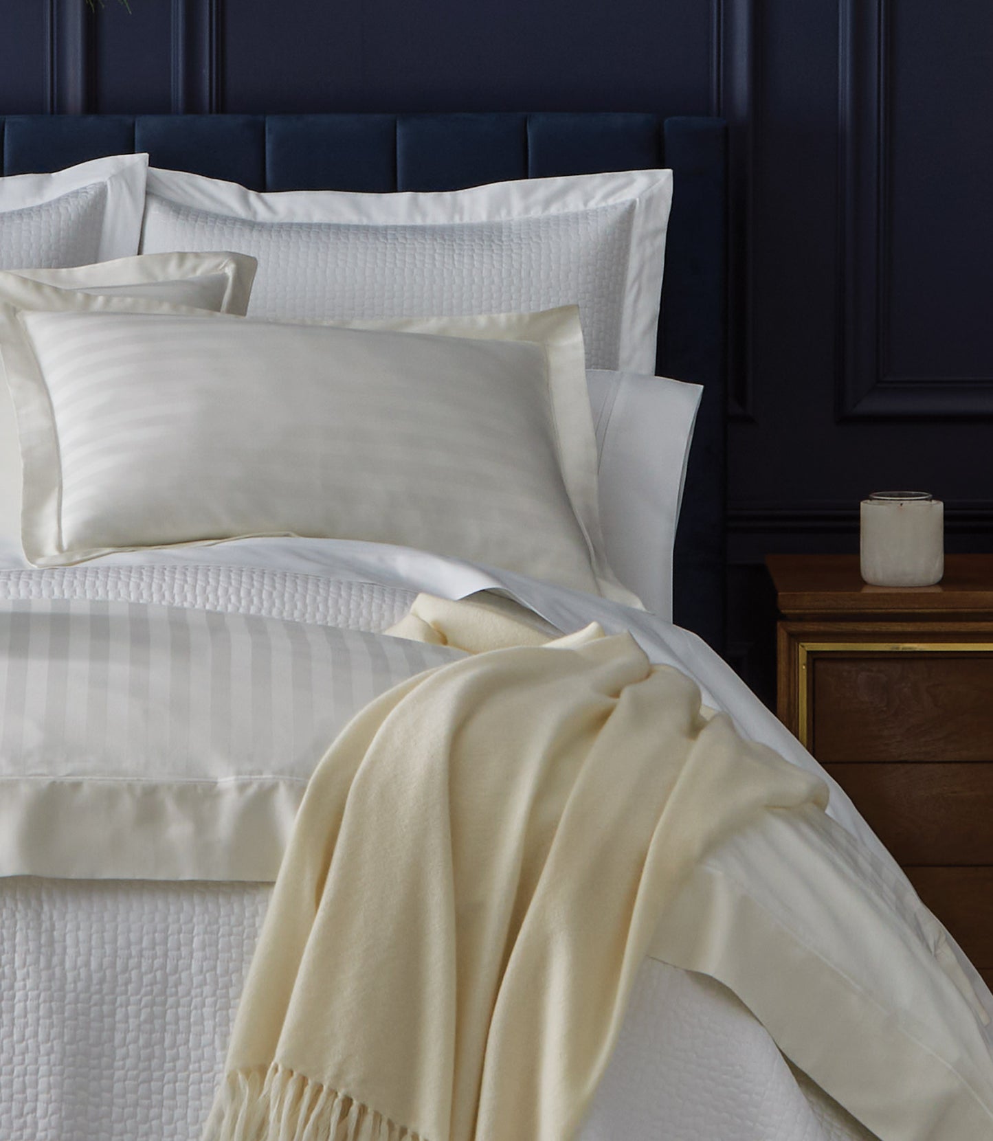 Soprano Stripe Sham on bed with blue headboard, Ivory