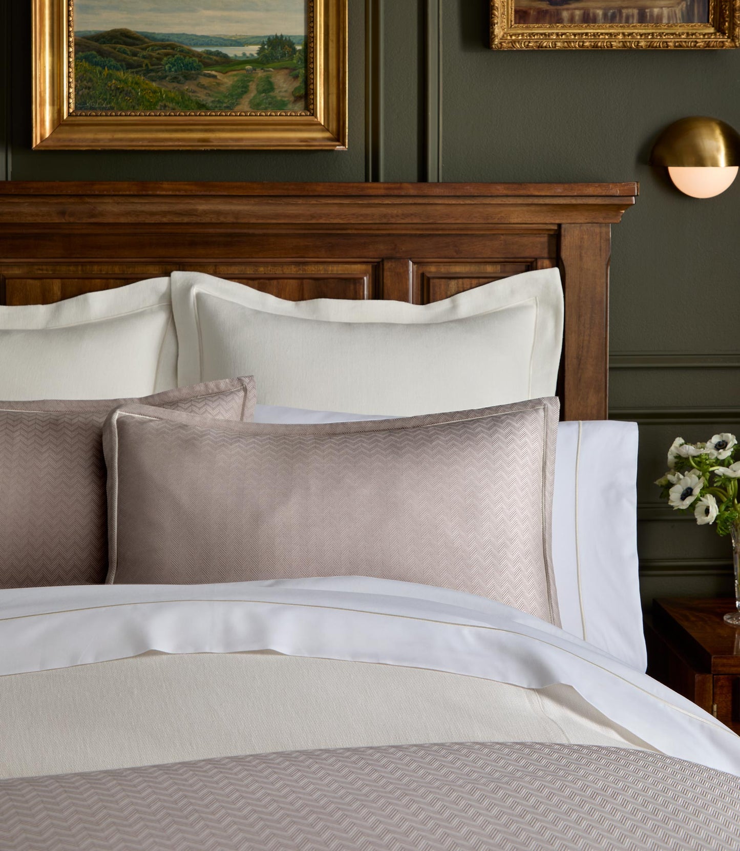 Savoy Jacquard Duvet and Sham styled on a bed with a wooden headboard, Platinum