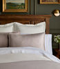 Savoy Jacquard Duvet and Sham styled on a bed with a wooden headboard, Platinum