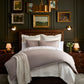 Savoy Jacquard Duvet Set styled in a bedroom scene set against a dark wood headboard, Platinum