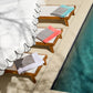 Soleil beach towels laid out on three lounge chairs by the pool