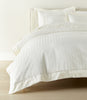 Soprano Stripe Duvet Cover displayed on a bed with a cream colored headboard, Ivory
