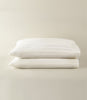 Soprano Stripe Sateen Pillowcases stacked on a beige background, Ivory