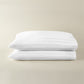 Soprano Stripe Sateen Pillowcases stacked on a beige background, White