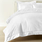 Soprano Stripe Duvet Cover displayed on a bed with a cream colored headboard, White