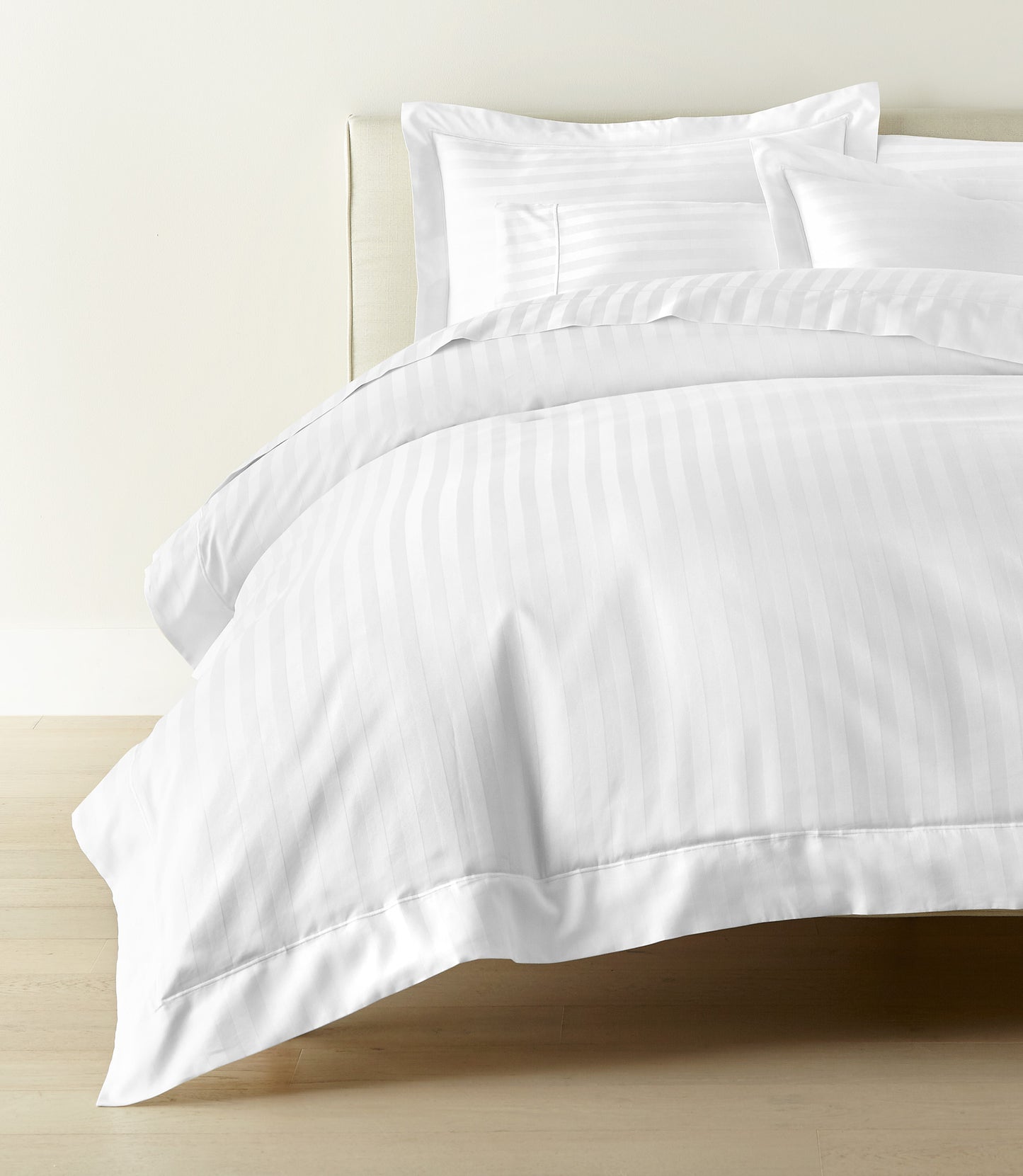 Soprano Stripe Duvet Cover displayed on a bed with a cream colored headboard, White