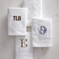 Four monogrammed Special Occasion Hand Towel lay flat