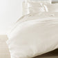 Lyric Duvet Cover and Shams on Bed in Ivory