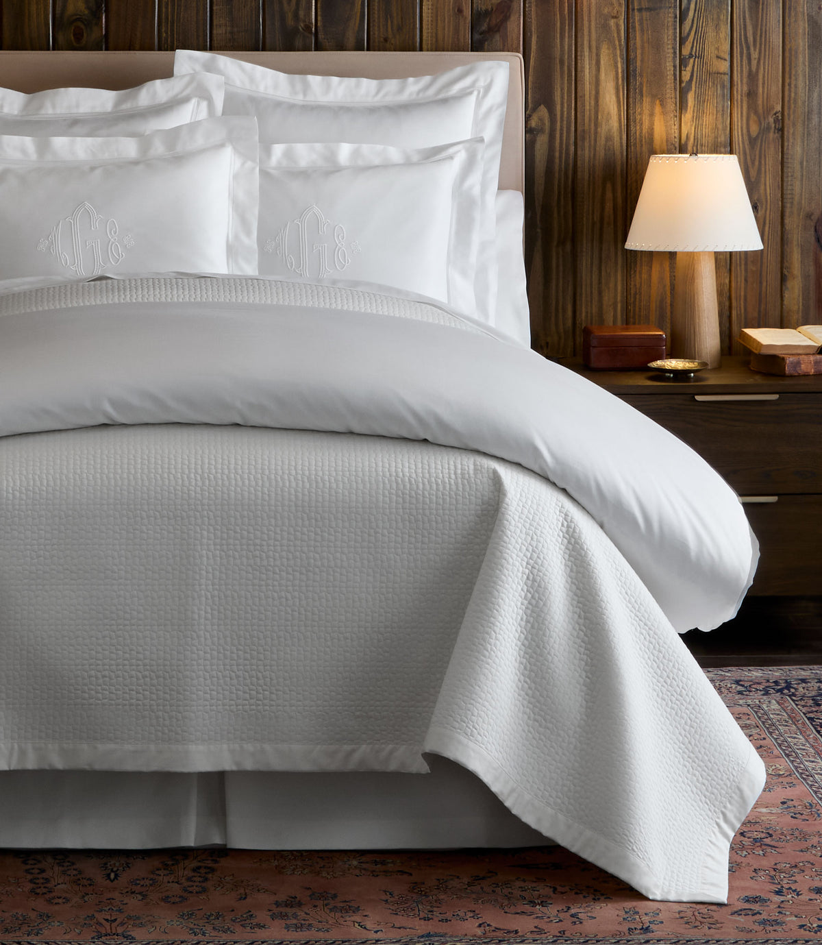 Hamilton Quilted Coverlet on bed in a cabin, White