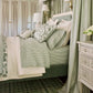 Windsor Stripe Classic Printed Sheet Set on a green bed in an elegant room with light green decorative curtains, Stripe Moss