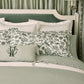 Windsor Stripe Classic Printed Sheet Set on a bed with a green headboard against light green curtains, Stripe Moss