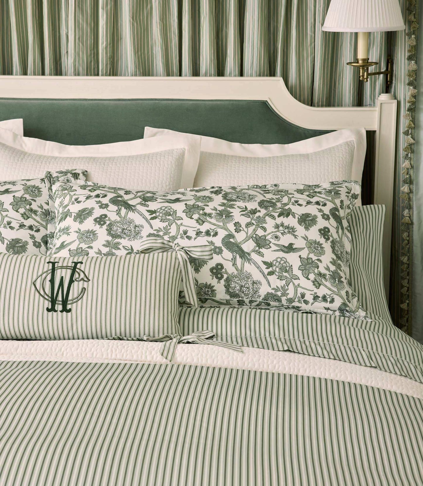 Windsor Stripe Classic Printed Sheet Set on a bed with a green headboard against light green curtains, Stripe Moss