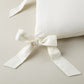 Detail of ribbon ties on the Windsor Stripe Oblong Pillow in Pearl