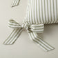 Detail of ribbon ties on the Windsor Stripe Oblong Pillow in Moss