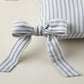 Detail of ribbon ties on the Windsor Stripe Oblong Pillow in Wedgewood