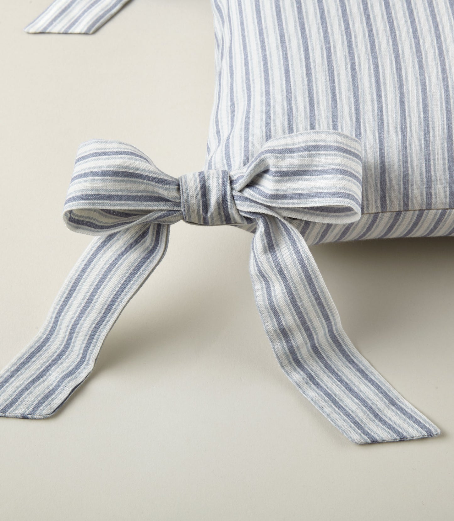 Detail of ribbon ties on the Windsor Stripe Oblong Pillow in Wedgewood