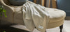 Vineyard throw blanket draped over a cream colored lounge chair