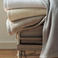 All Seasons Cotton Blanket Stack on Chair in Multiple Colors White Linen FLint