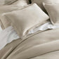 Angie Stonewashed Matelasse Shams on bed Dune