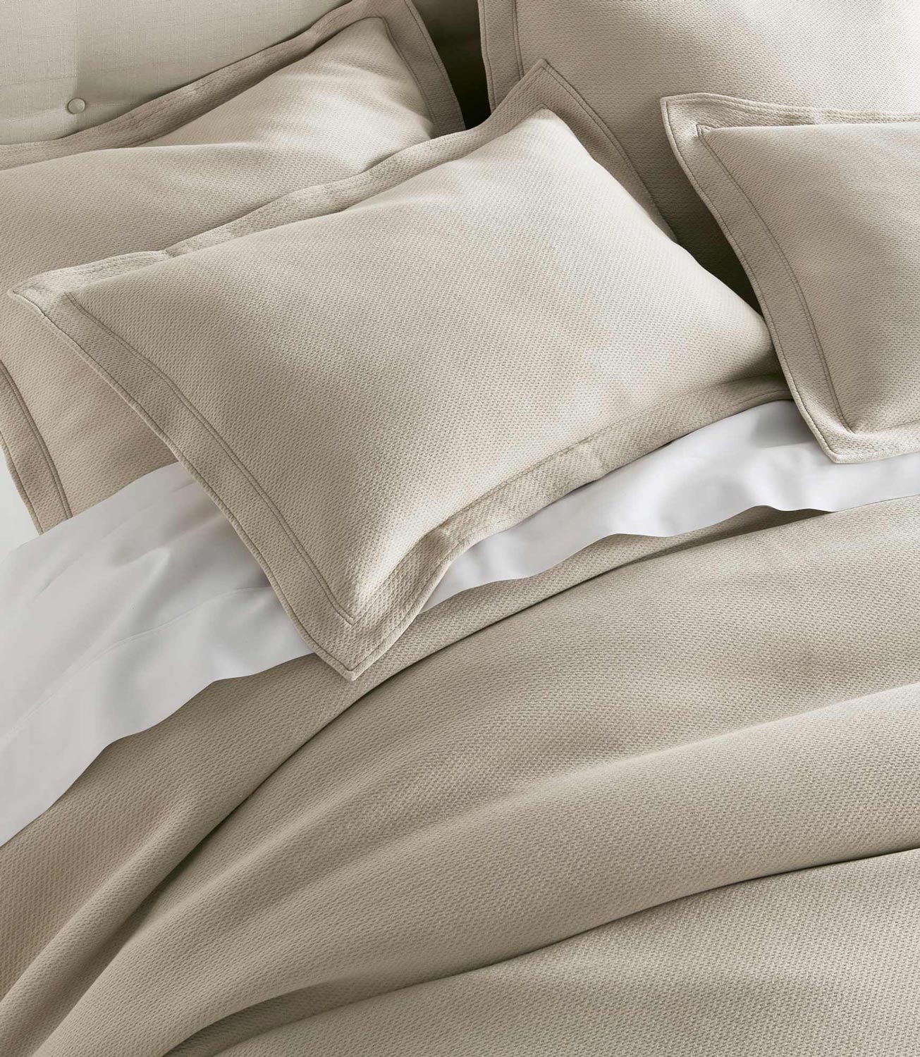 Angie Stonewashed Matelasse Shams on bed Dune