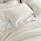 Angie Stonewashed Matelasse Shams on bed Pearl