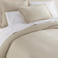 Angie Stonewashed Matelasse Shams on bed Dune