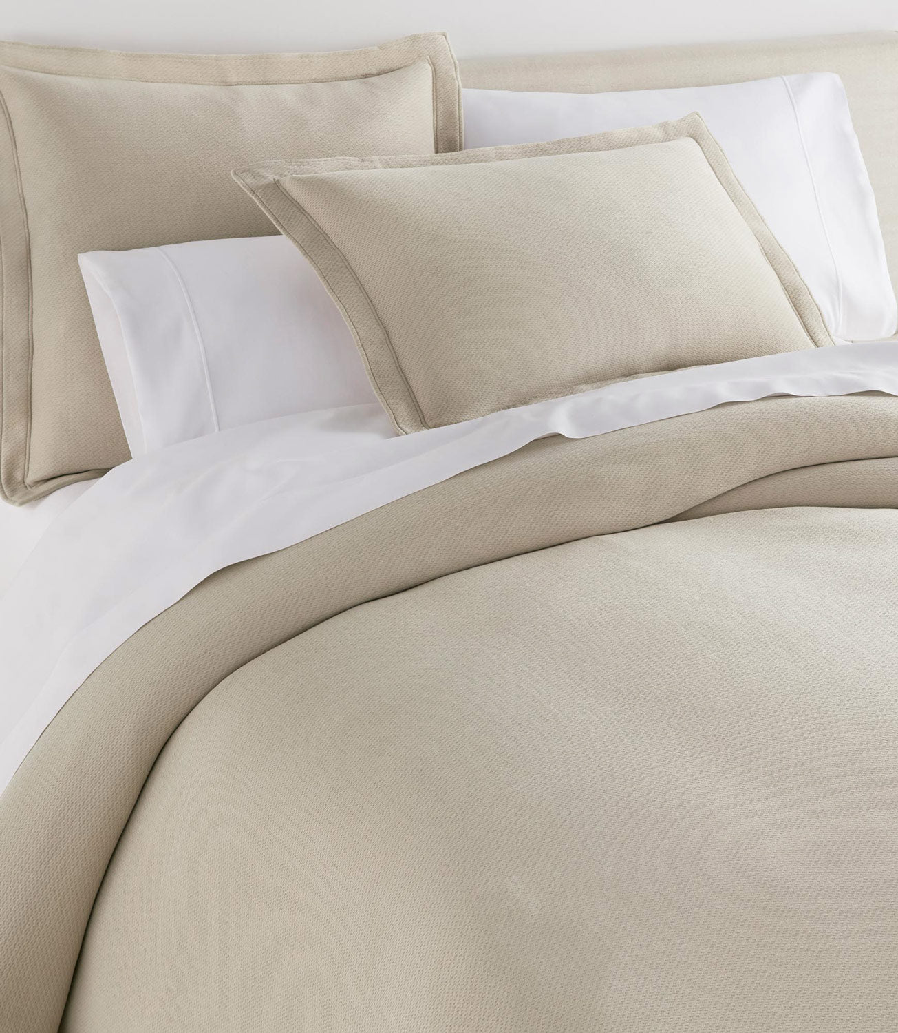 Angie Stonewashed Matelasse Shams on bed Dune