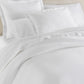 Angie Stonewashed Matelasse Shams on bed White