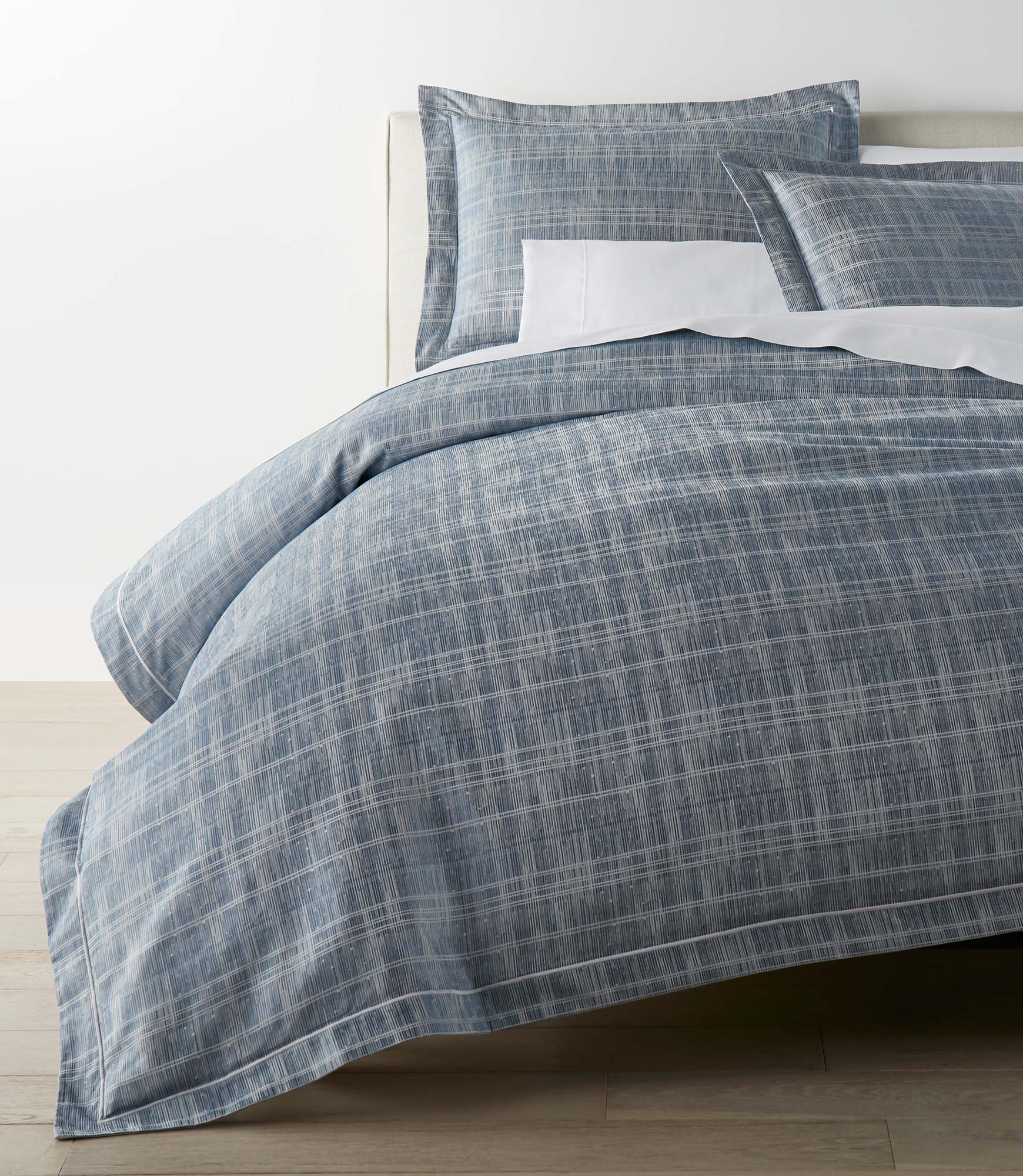 Biagio Azure Duvet Cover on a Bed