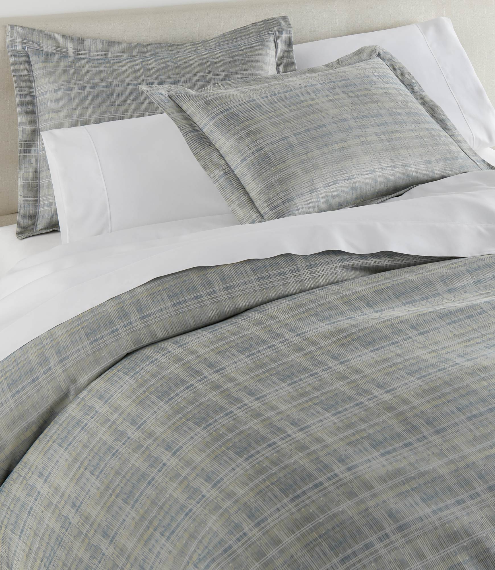 Biagio Jacquard Shams on bed Aloe