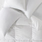 white goose down pillows and duvet on bed