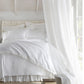 all white bedding with Ellie ruffled pillow shams