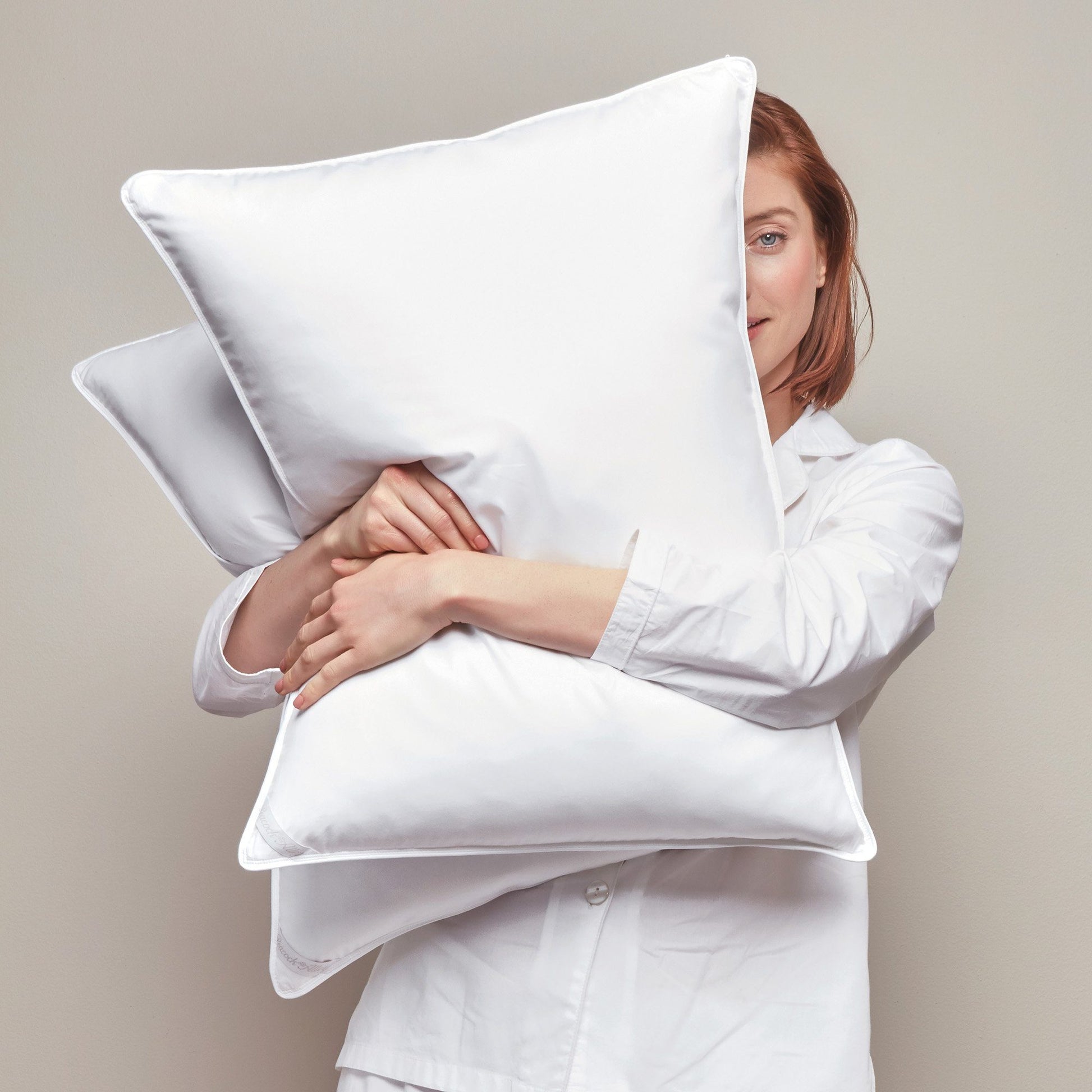 Down Alternative Pillow held by Model close White